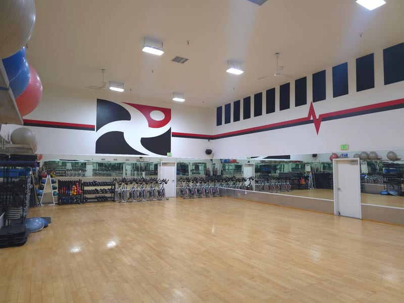 Fitness studio with exercise equipment and mirrors